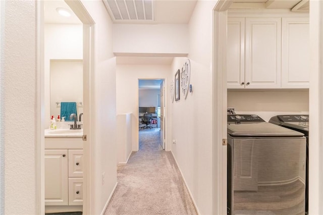 7155 Citrus Ave Unit 367, Fontana, CA 92336 - hallway with washer and dryer, light carpet, a sink, and baseboards