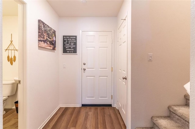 7155 Citrus Ave Unit 367, Fontana, CA 92336 - doorway featuring dark wood-type flooring, stairway, and baseboards