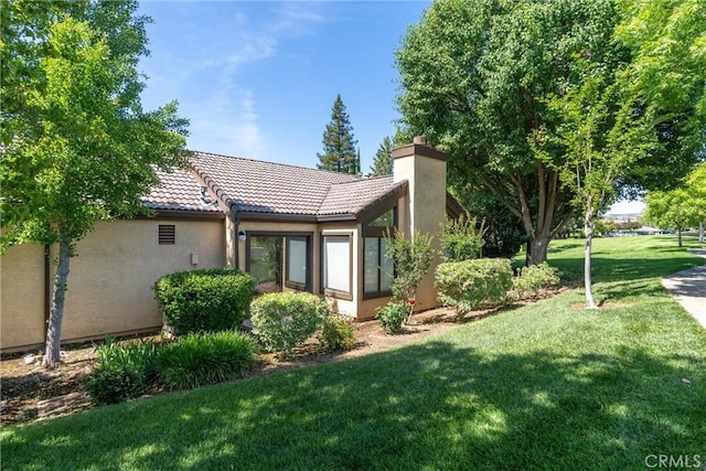 9 Coolwater, Chico, CA 95928 - rear view of house featuring a tiled roof, stucco siding, a lawn, and a chimney