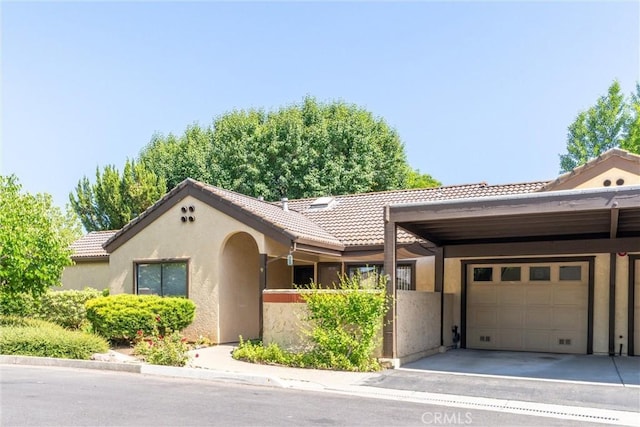 9 Coolwater, Chico, CA 95928 - view of front of house with stucco siding, a garage, a tiled roof, and driveway