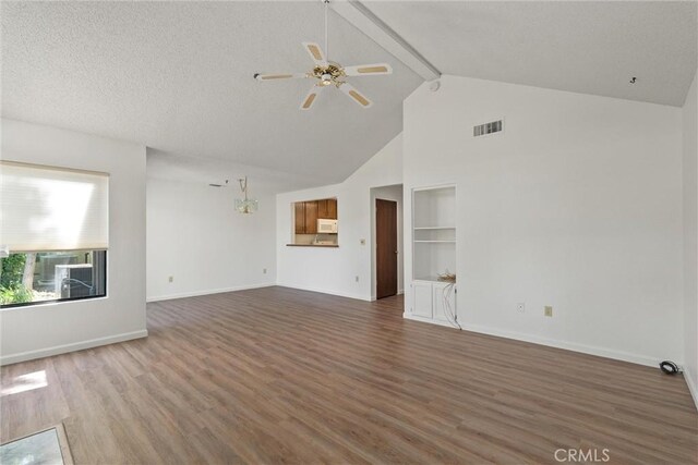 9 Coolwater, Chico, CA 95928 - unfurnished living room with wood finished floors, ceiling fan, built in features, baseboards, and beam ceiling