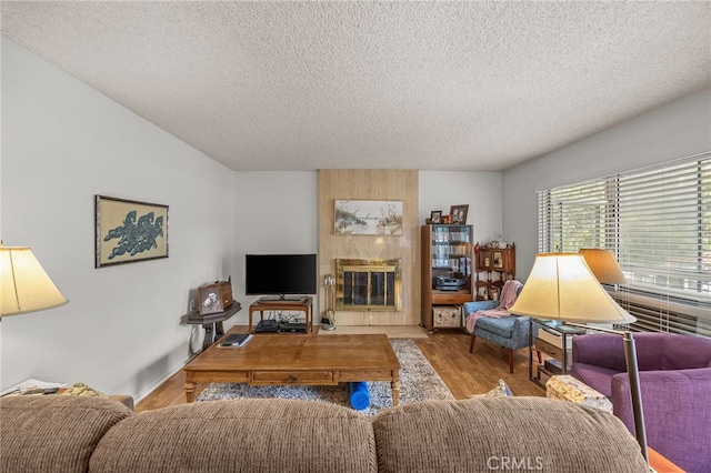 5359 Algarrobo Unit 1A, Laguna Woods, CA 92637 - living area with wood finished floors, a textured ceiling, and a tile fireplace