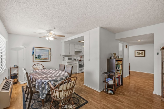 5359 Algarrobo Unit 1A, Laguna Woods, CA 92637 - dining room featuring ceiling fan, wood finished floors, a textured ceiling, and baseboards