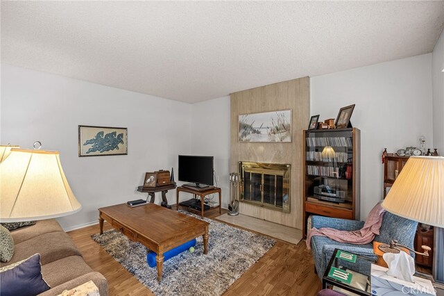 5359 Algarrobo Unit 1A, Laguna Woods, CA 92637 - living room with wood finished floors, a textured ceiling, and a tile fireplace