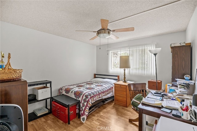 5359 Algarrobo Unit 1A, Laguna Woods, CA 92637 - bedroom with wood finished floors, a textured ceiling, a desk, and ceiling fan