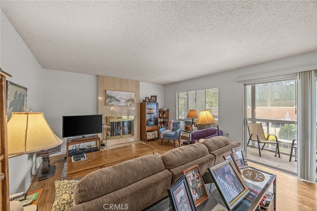 5359 Algarrobo Unit 1A, Laguna Woods, CA 92637 - living room with a textured ceiling, wood finished floors, and a tiled fireplace