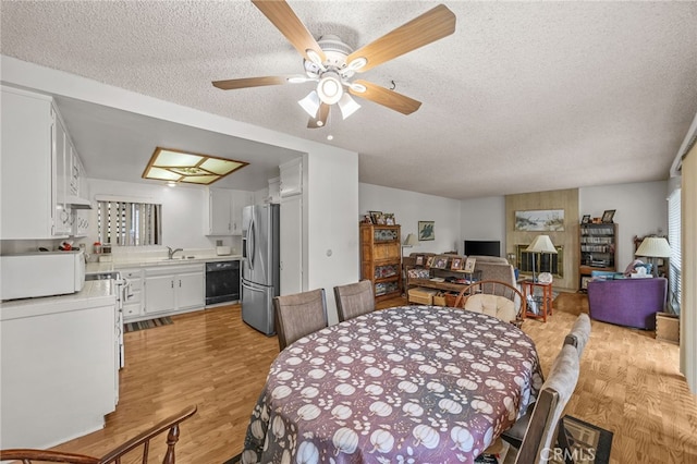 5359 Algarrobo Unit 1A, Laguna Woods, CA 92637 - dining area featuring light wood-style flooring, a textured ceiling, and a ceiling fan
