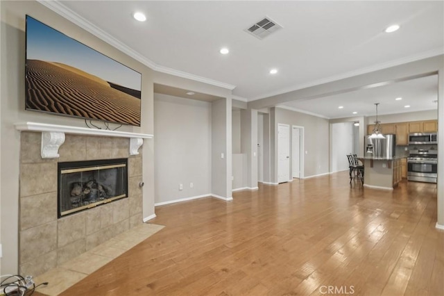28523 Santa Catarina Rd, Saugus, CA 91350 - unfurnished living room with light wood-type flooring, a fireplace, recessed lighting, crown molding, and baseboards