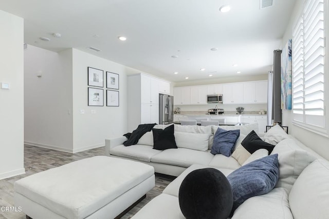 1607 Dundas Pl, Upland, CA 91784 - living room with light wood finished floors, recessed lighting, and baseboards