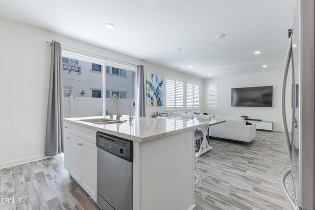 1607 Dundas Pl, Upland, CA 91784 - kitchen featuring appliances with stainless steel finishes, a sink, white cabinetry, an island with sink, and light wood-style floors