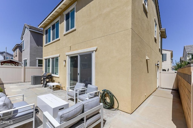 1607 Dundas Pl, Upland, CA 91784 - back of property featuring a patio, stucco siding, a fenced backyard, and an outdoor hangout area