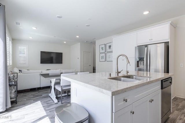 1607 Dundas Pl, Upland, CA 91784 - kitchen featuring stainless steel appliances, a sink, wood finished floors, white cabinets, and light stone countertops