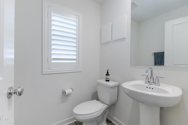1607 Dundas Pl, Upland, CA 91784 - bathroom featuring baseboards, toilet, and plenty of natural light