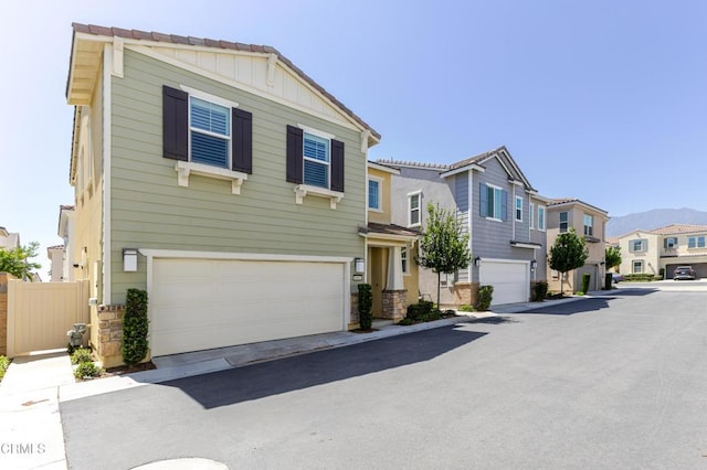 1607 Dundas Pl, Upland, CA 91784 - view of front of property featuring a residential view, an attached garage, stone siding, and board and batten siding