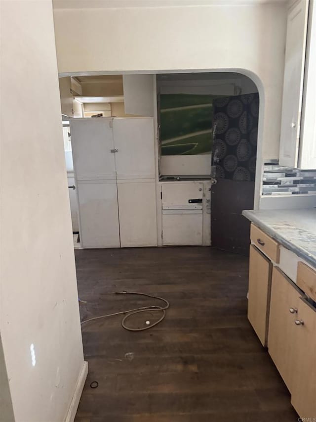 704 J St, Chula Vista, CA 91910 - kitchen featuring dark wood-type flooring, arched walkways, decorative backsplash, and light countertops