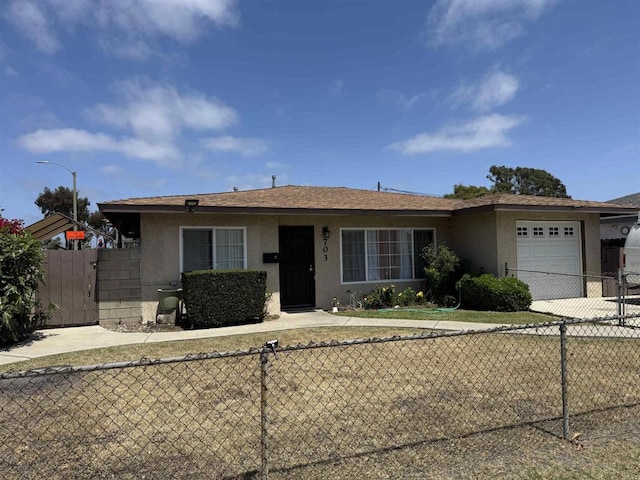 704 J St, Chula Vista, CA 91910 - view of front of house with stucco siding, a garage, and driveway