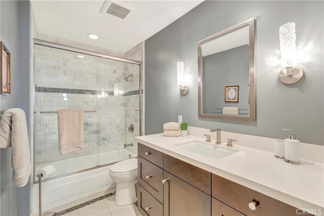 14096 Baker St, Westminster, CA 92683 - bathroom with vanity, combined bath / shower with glass door, toilet, and tile patterned floors