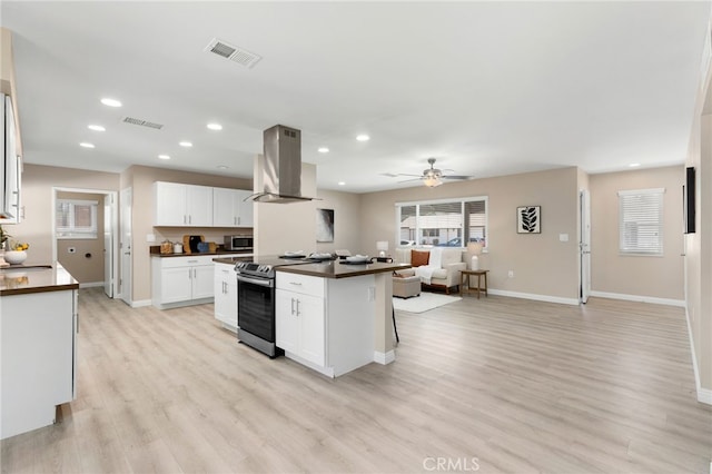 26331 Foxgrove Rd, Menifee, CA 92586 - kitchen with island exhaust hood, stainless steel appliances, open floor plan, dark countertops, and light wood-style floors