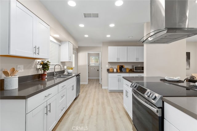 26331 Foxgrove Rd, Menifee, CA 92586 - kitchen with stainless steel appliances, island exhaust hood, a sink, dark countertops, and light wood-type flooring