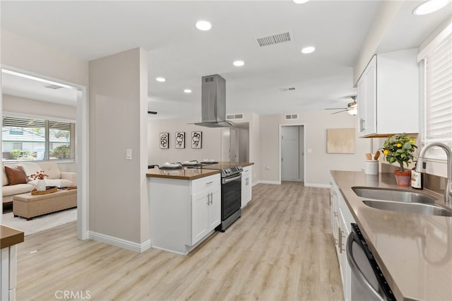 26331 Foxgrove Rd, Menifee, CA 92586 - kitchen featuring island exhaust hood, stainless steel appliances, a sink, light wood-style floors, and recessed lighting
