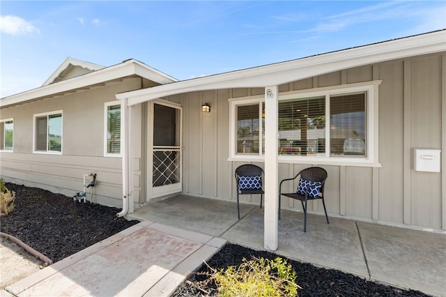 26331 Foxgrove Rd, Menifee, CA 92586 - doorway to property with a patio area and board and batten siding