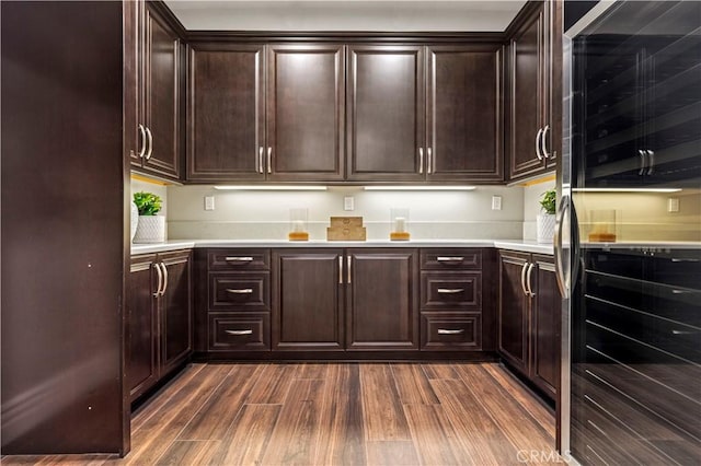 51 Dunmore, Irvine, CA 92620 - kitchen with freestanding refrigerator, dark wood-type flooring, light countertops, and dark brown cabinets