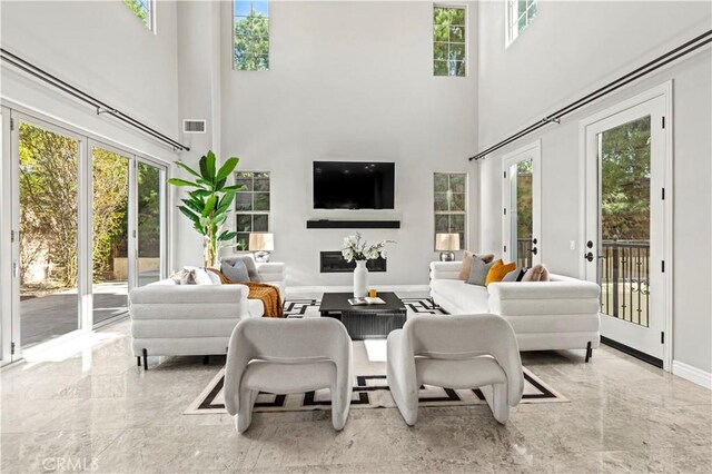 51 Dunmore, Irvine, CA 92620 - living area with a towering ceiling, marble tiled flooring, and baseboards