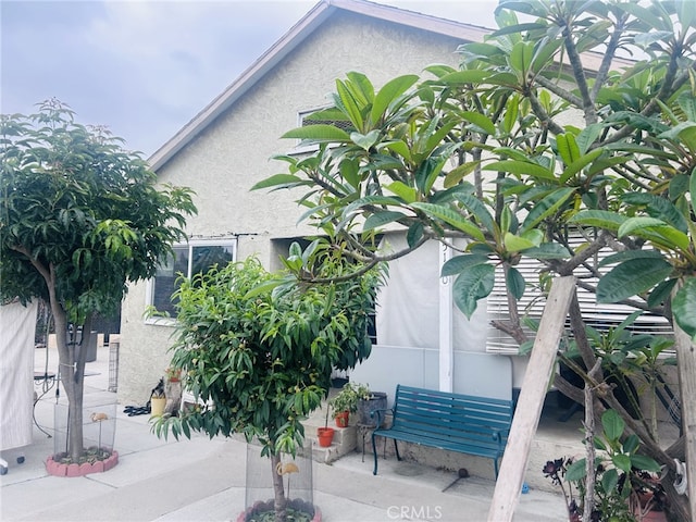15160 Pimenta Ave, Paramount, CA 90723 - view of home's exterior featuring stucco siding and a patio