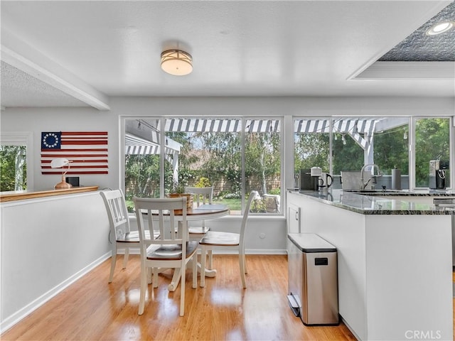 23403 Via Castanet, Valencia, CA 91355 - dining room featuring light wood-style flooring and baseboards