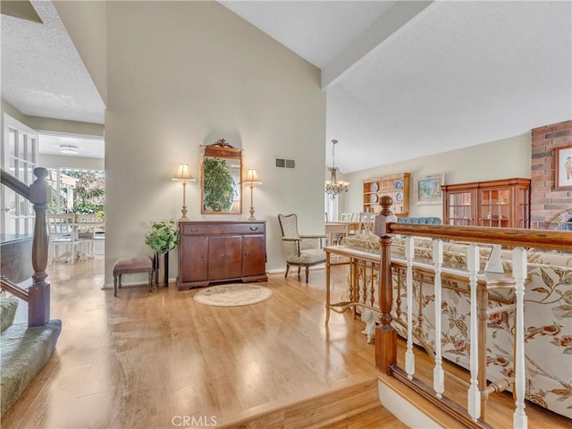 23403 Via Castanet, Valencia, CA 91355 - entrance foyer featuring high vaulted ceiling, a chandelier, wood finished floors, stairway, and beamed ceiling