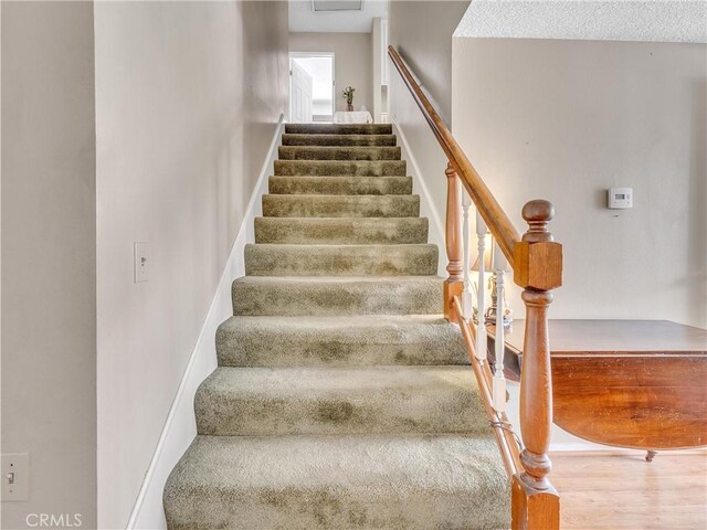 23403 Via Castanet, Valencia, CA 91355 - stairs featuring wood finished floors and baseboards