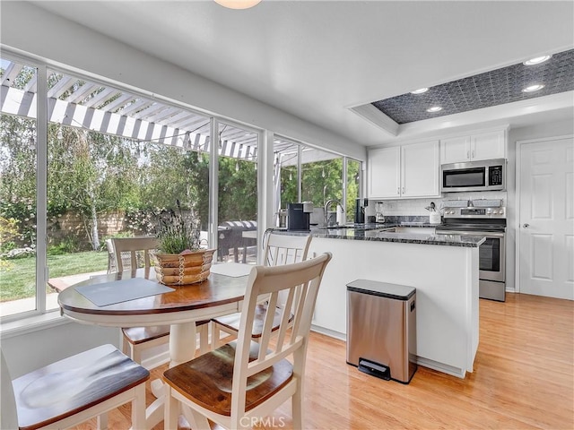 23403 Via Castanet, Valencia, CA 91355 - kitchen featuring stainless steel appliances, healthy amount of natural light, white cabinetry, light wood-style flooring, and recessed lighting