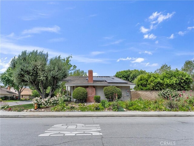 23403 Via Castanet, Valencia, CA 91355 - view of front of property with roof mounted solar panels and a chimney