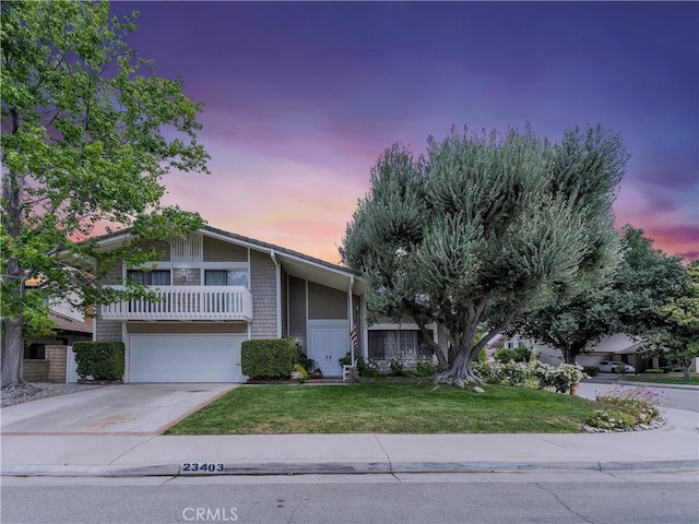 23403 Via Castanet, Valencia, CA 91355 - view of front of house featuring a yard, concrete driveway, a garage, and a balcony
