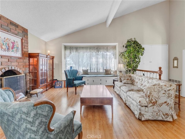 23403 Via Castanet, Valencia, CA 91355 - living area with wood finished floors, a fireplace, and a textured ceiling