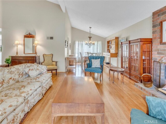 23403 Via Castanet, Valencia, CA 91355 - living area featuring a chandelier, wood finished floors, high vaulted ceiling, and baseboards