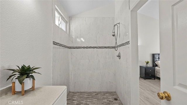 10133 Shinon Dr, Rancho Cucamonga, CA 91737 - bathroom with tiled shower, ensuite bath, vaulted ceiling, and wood finished floors