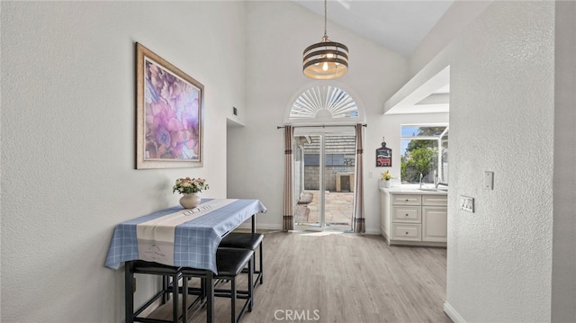 10133 Shinon Dr, Rancho Cucamonga, CA 91737 - entrance foyer featuring light wood-type flooring, a chandelier, baseboards, high vaulted ceiling, and a textured wall
