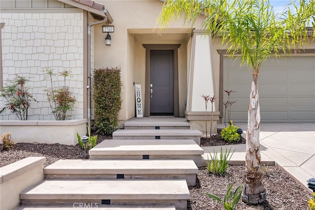 2760 Chad Zeller Ln, Corona, CA 92882 - view of exterior entry with a garage, concrete driveway, and stucco siding
