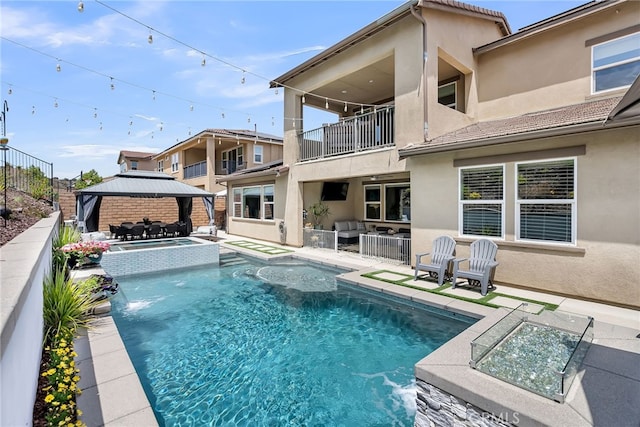2760 Chad Zeller Ln, Corona, CA 92882 - back of property featuring a balcony, a gazebo, outdoor lounge area, stucco siding, and a patio
