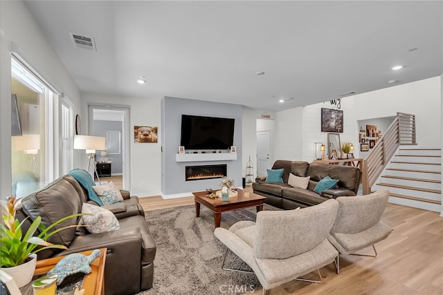 2760 Chad Zeller Ln, Corona, CA 92882 - living area featuring light wood-style floors, stairway, a glass covered fireplace, and recessed lighting