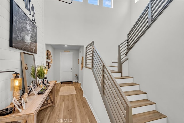 2760 Chad Zeller Ln, Corona, CA 92882 - foyer entrance with a high ceiling, light wood-style flooring, stairway, and baseboards