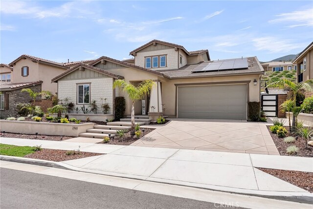 2760 Chad Zeller Ln, Corona, CA 92882 - view of front of home with roof mounted solar panels, an attached garage, concrete driveway, stucco siding, and a tile roof