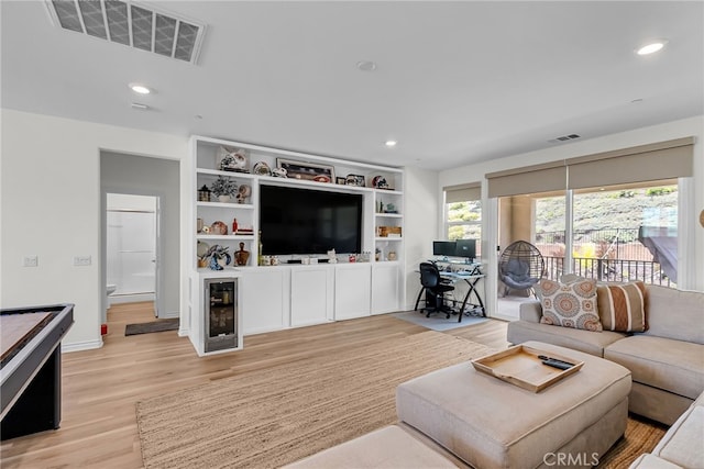 2760 Chad Zeller Ln, Corona, CA 92882 - living area featuring beverage cooler, light wood-style flooring, recessed lighting, a desk, and baseboards