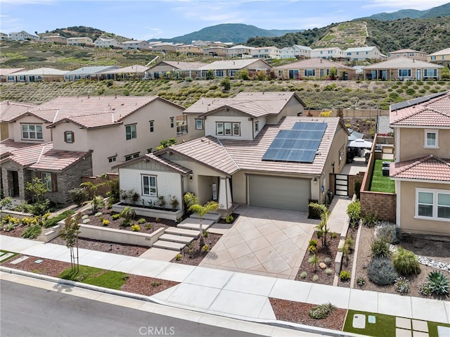 2760 Chad Zeller Ln, Corona, CA 92882 - view of front of property with a residential view, solar panels, a mountain view, driveway, and stucco siding