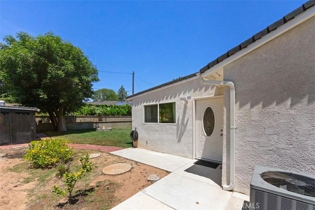 3275 Dalhart Ave, Simi Valley, CA 93063 - view of exterior entry featuring stucco siding, cooling unit, and a patio