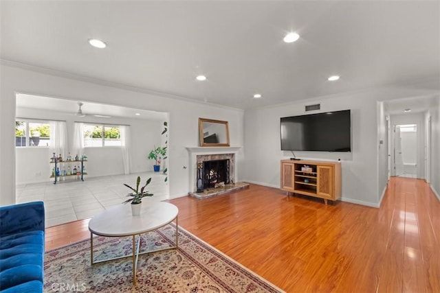 3275 Dalhart Ave, Simi Valley, CA 93063 - living area with ornamental molding, a premium fireplace, recessed lighting, baseboards, and light wood finished floors