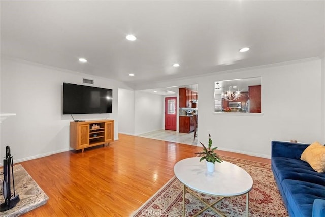 3275 Dalhart Ave, Simi Valley, CA 93063 - living area with light wood finished floors, ornamental molding, baseboards, and recessed lighting
