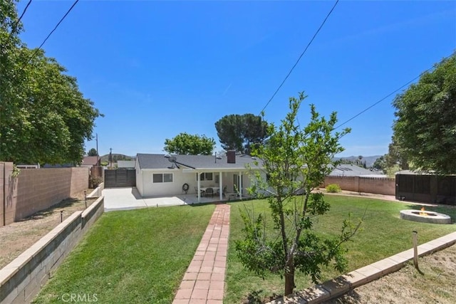 3275 Dalhart Ave, Simi Valley, CA 93063 - rear view of property with an outdoor fire pit and a patio area
