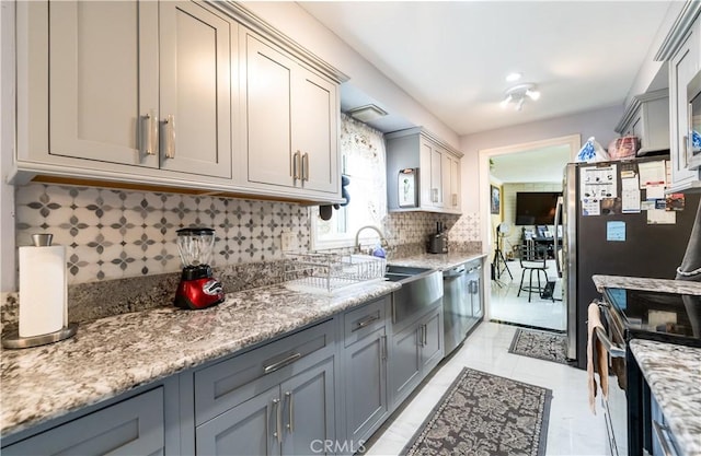 727 W Hill St, Long Beach, CA 90806 - kitchen featuring a sink, gray cabinets, stainless steel appliances, and tasteful backsplash